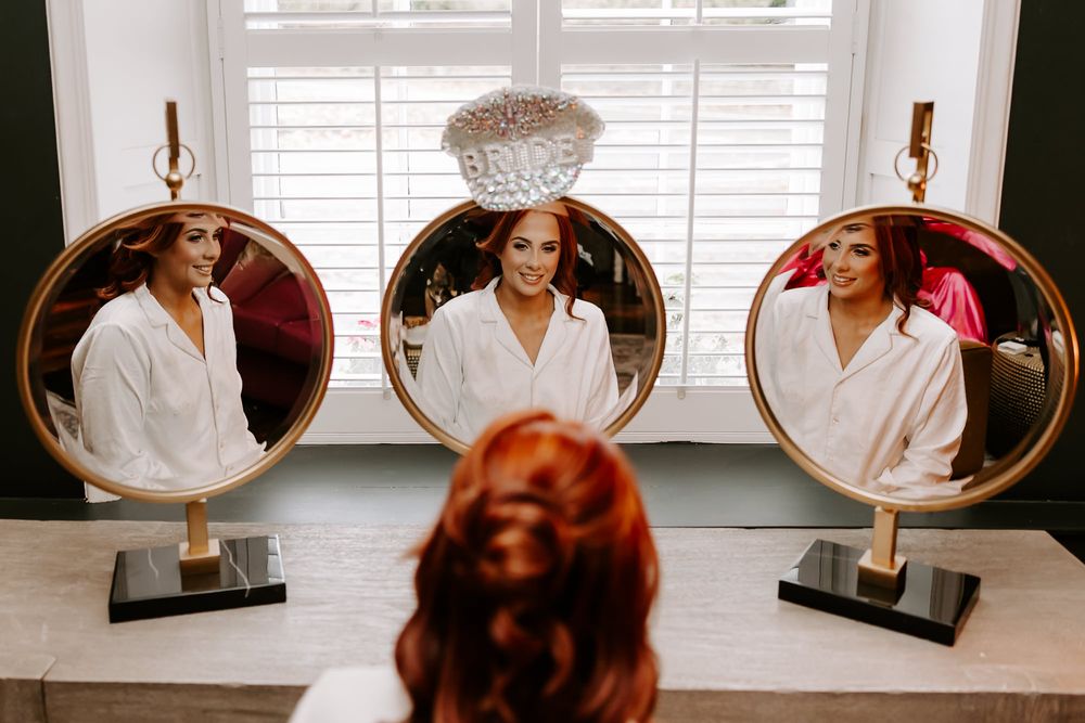 A series of eight connected photos showing someone in a white robe sitting and posing by a window with shutters.