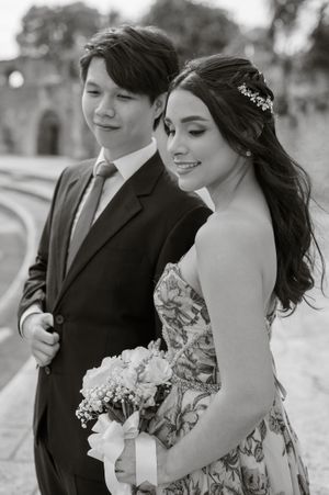 A romantic black and white photo series of a couple in formal attire posing outdoors.