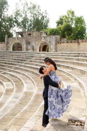 A romantic couple embraces and poses on ancient stone amphitheater steps in a series of artistic photos.