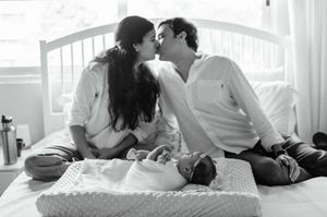 A romantic couple shares intimate moments in a series of black and white photographs on a bed.