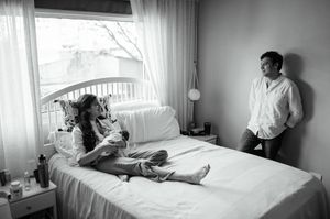 Black and white photo series showing tender moments between parent and newborn in hospital room setting.