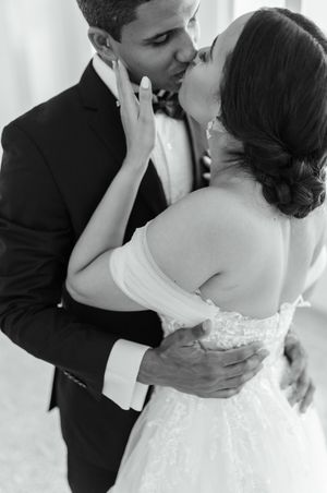 A series of tender wedding photos showing a couple in black and white formal attire embracing in an elegant setting.