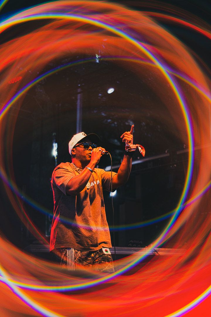Multiple light painting images showing swirling orange and red light trails creating dynamic spiral patterns in darkness.