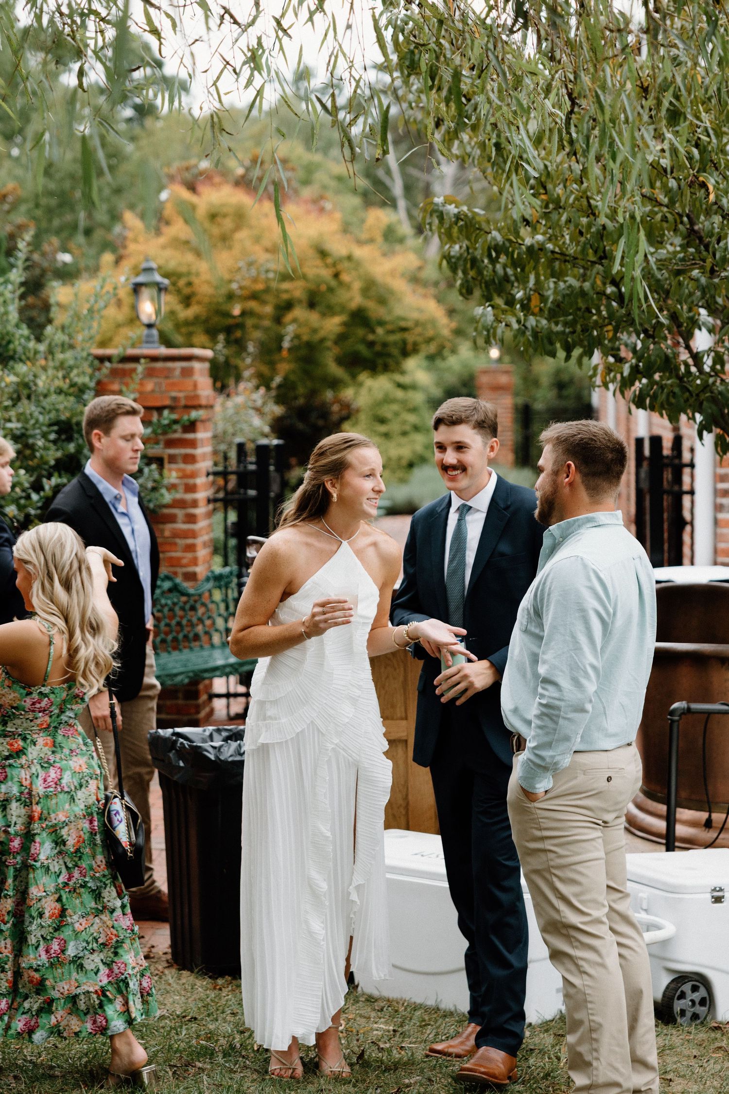 A series of candid moments from an outdoor wedding reception showing guests mingling and celebrating together.