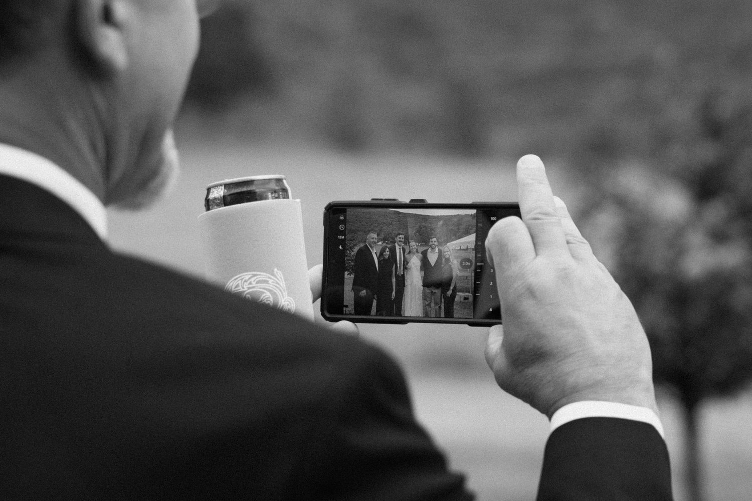 A sequence of black and white photos showing someone holding a camera lens and taking photos outdoors.