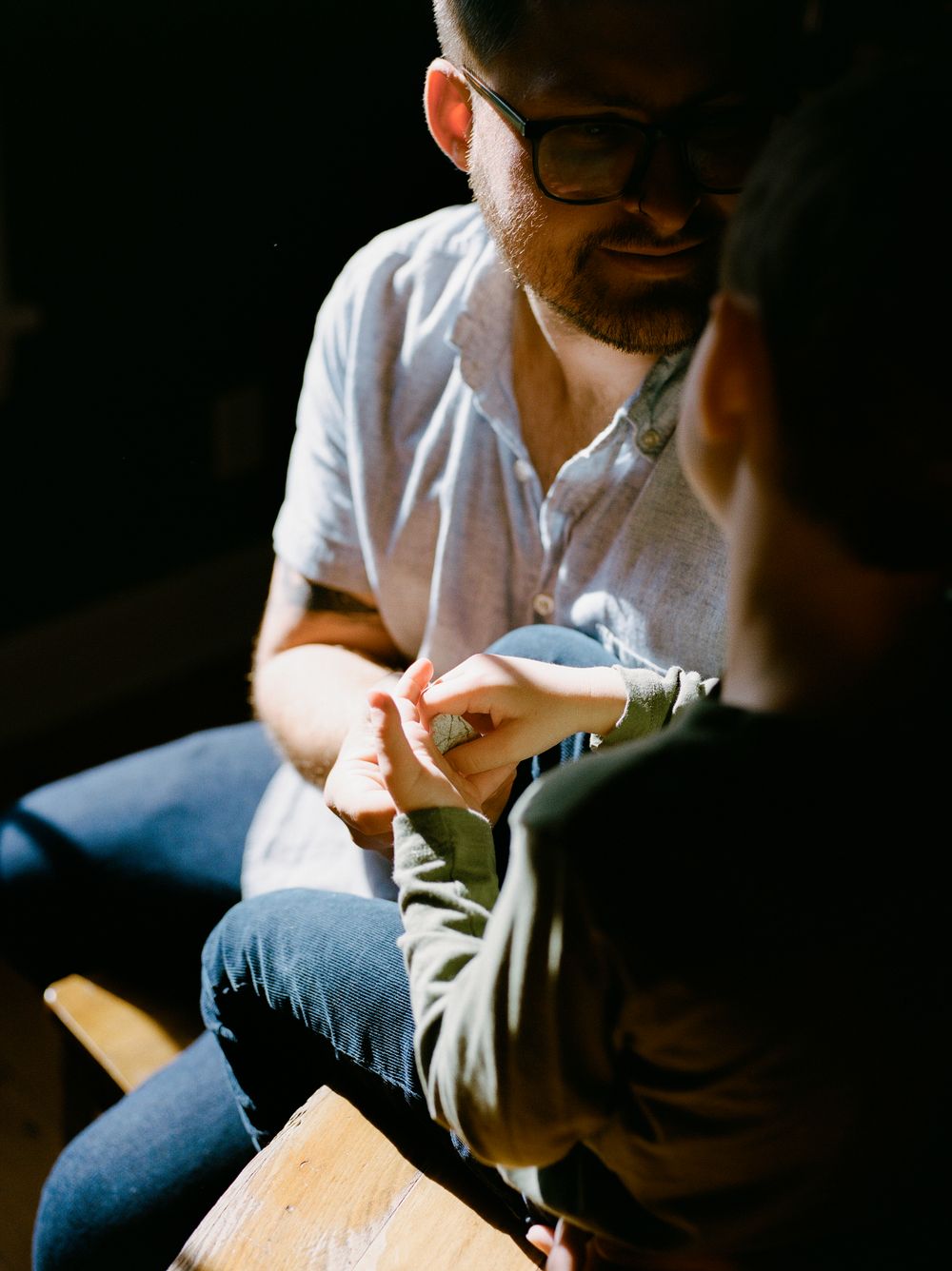 Moody low-light photographs showing intimate family interactions.