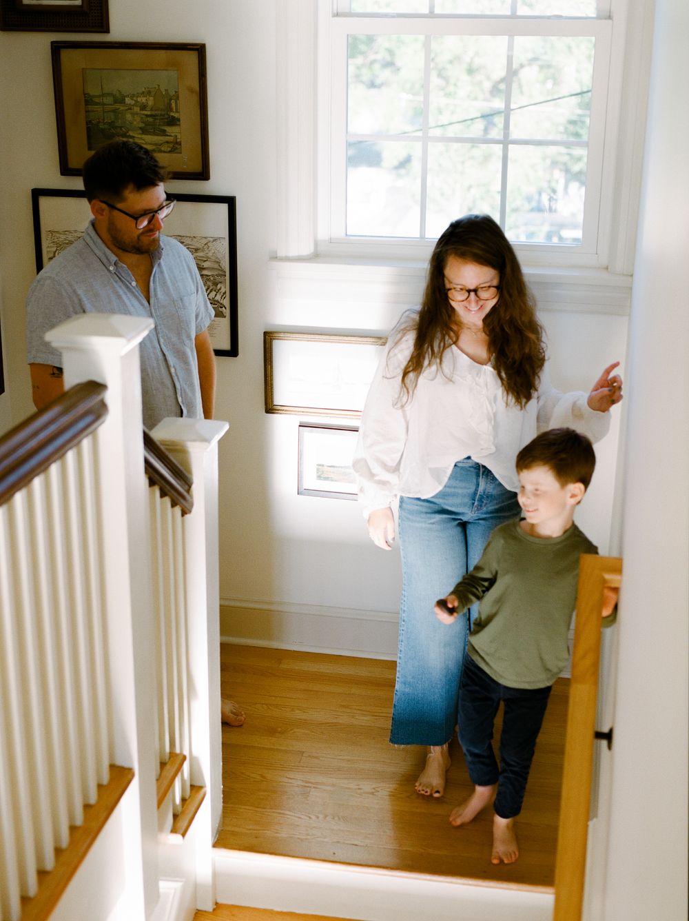 Sequence of playful interactions between people in a sunlit home interior with white walls.