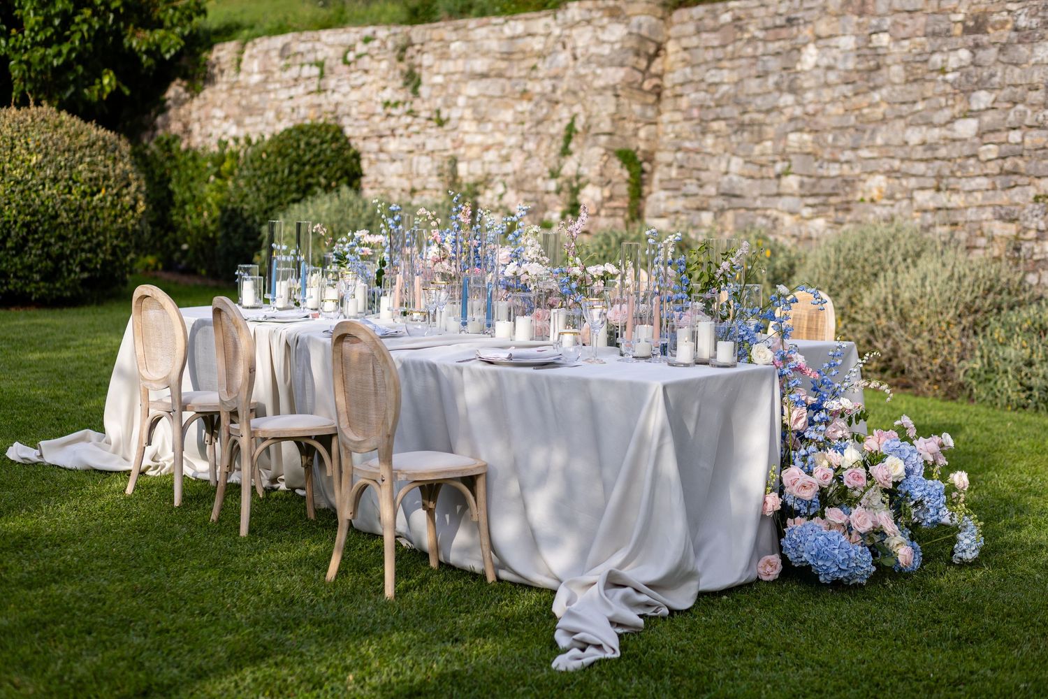 Fine art wedding details featuring pastel florals and golden tableware in Assisi.