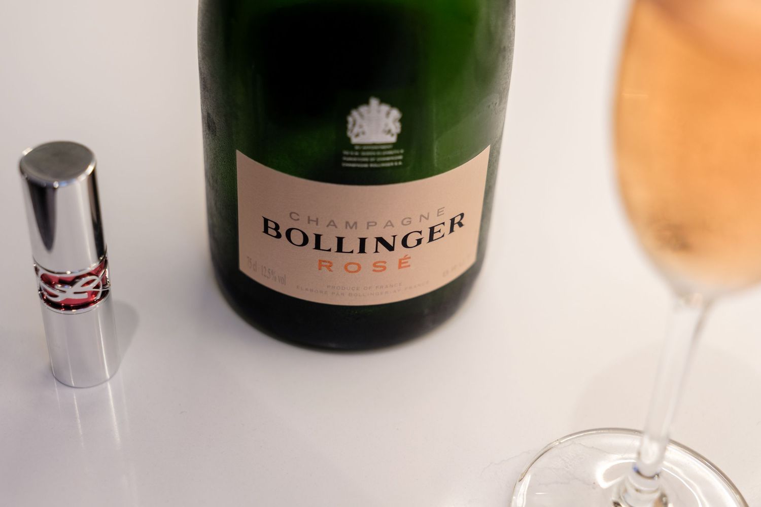 A collection of champagne bottles including Bollinger and other luxury brands displayed on a counter.