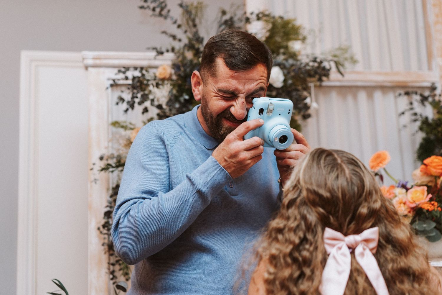 Candid moments captured during wedding reception festivities with natural decor.