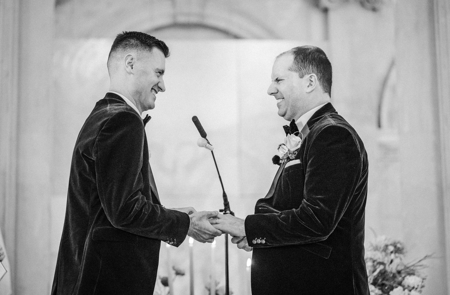A black and white photo collage showing multiple angles of a couple exchanging rings during a wedding ceremony.