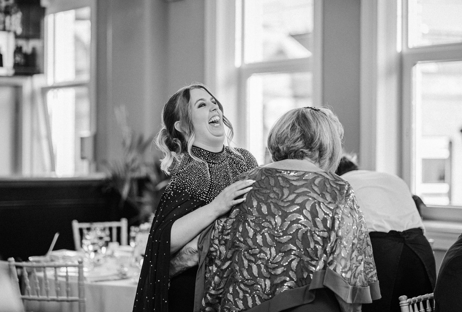 A black and white photo montage showing intimate family moments in a home setting.