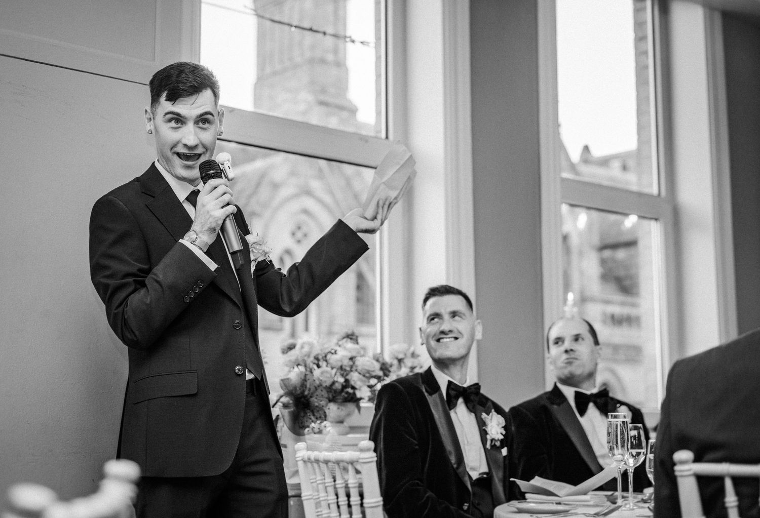 A series of black and white wedding photos showing candid moments during a ceremony and reception.