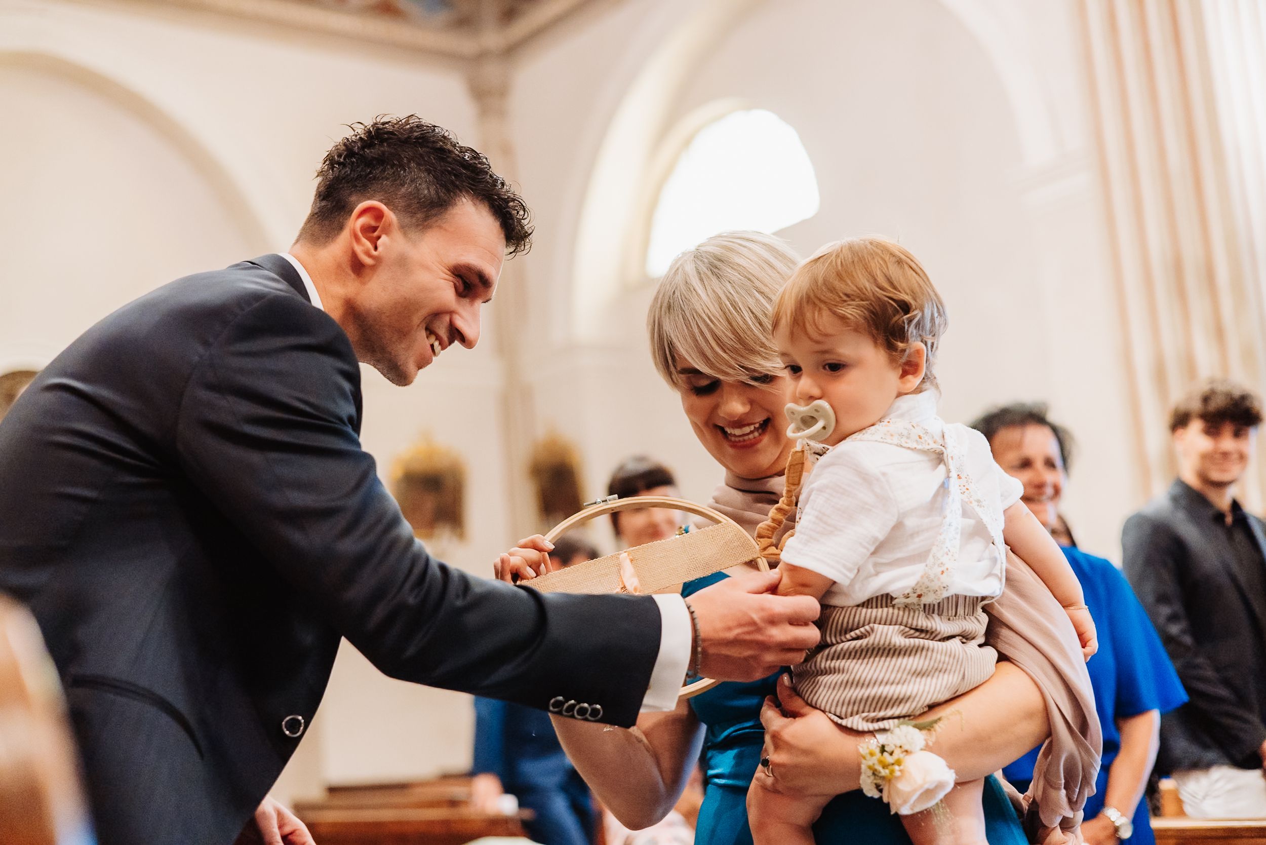 Wedding guests share a joyful moment during a reception celebration in an elegant venue.