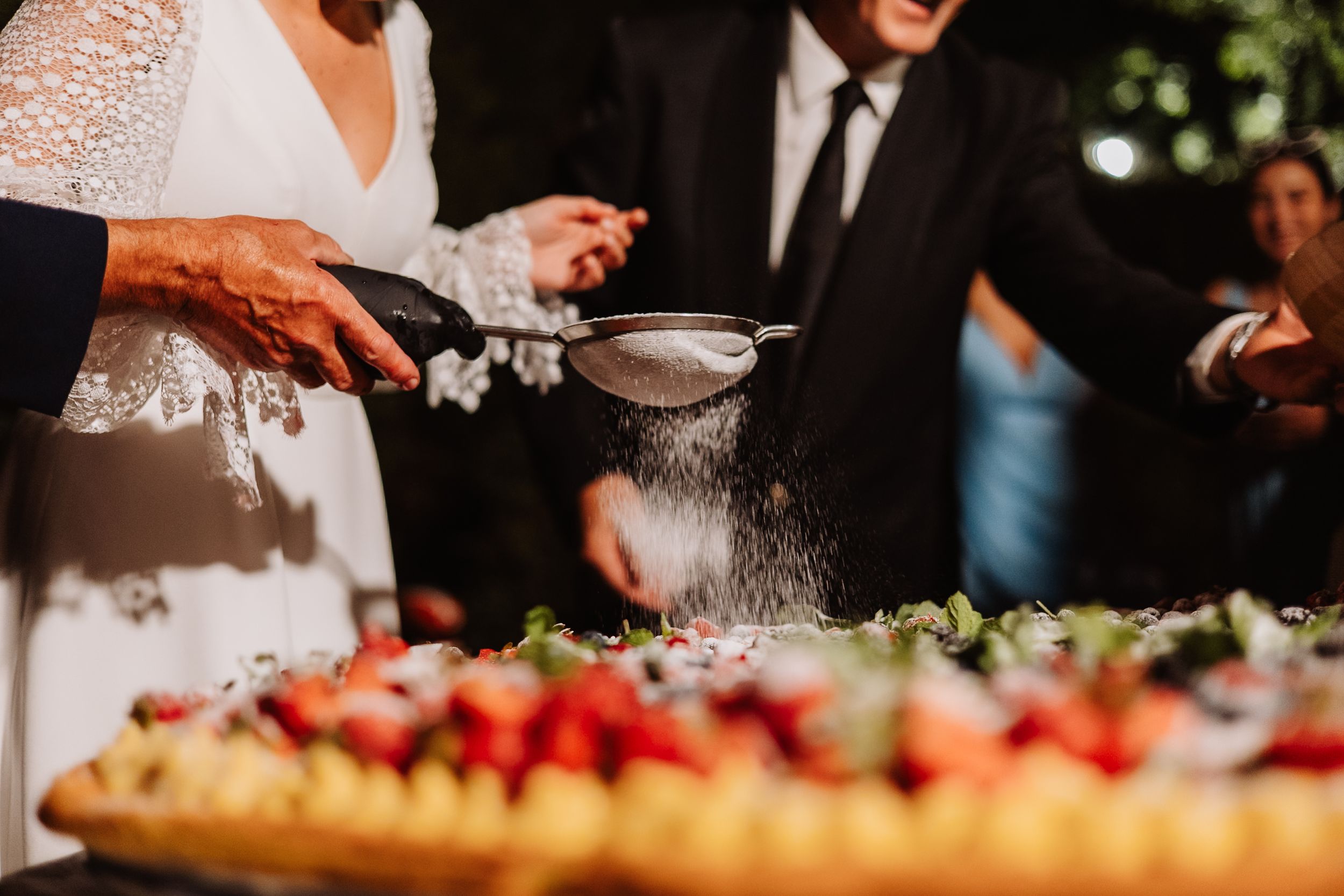 Fresh ingredients and toppings laid out at a gourmet pizza station during an outdoor event.