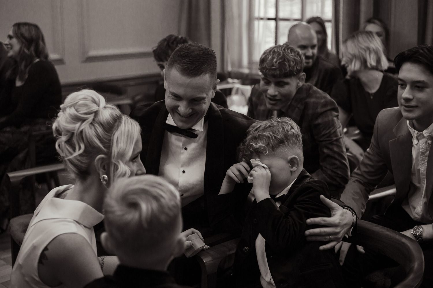 the bride and bestman comfort the bride's son as he is overcome with emotion watching his parents get married at old marylebone town hall