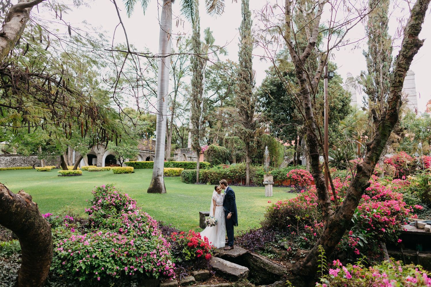 Lush garden wedding venue with blooming azaleas and winding pathways.