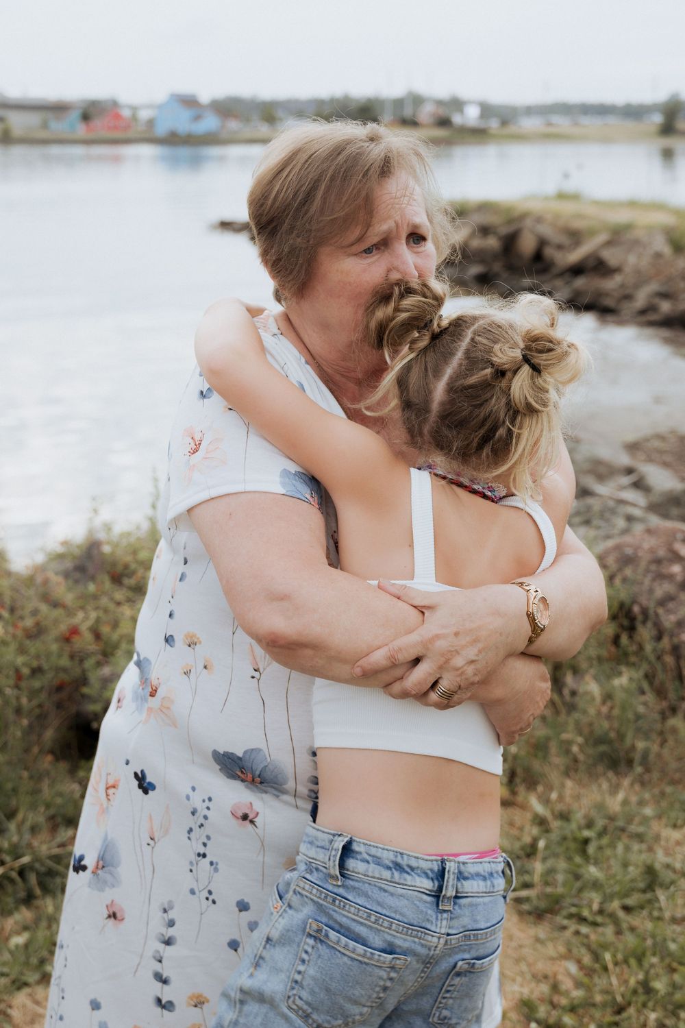 Grandmother hugging her granddaughter during extended family photography session in New Brunswick photographer, fun family photos, outdoor