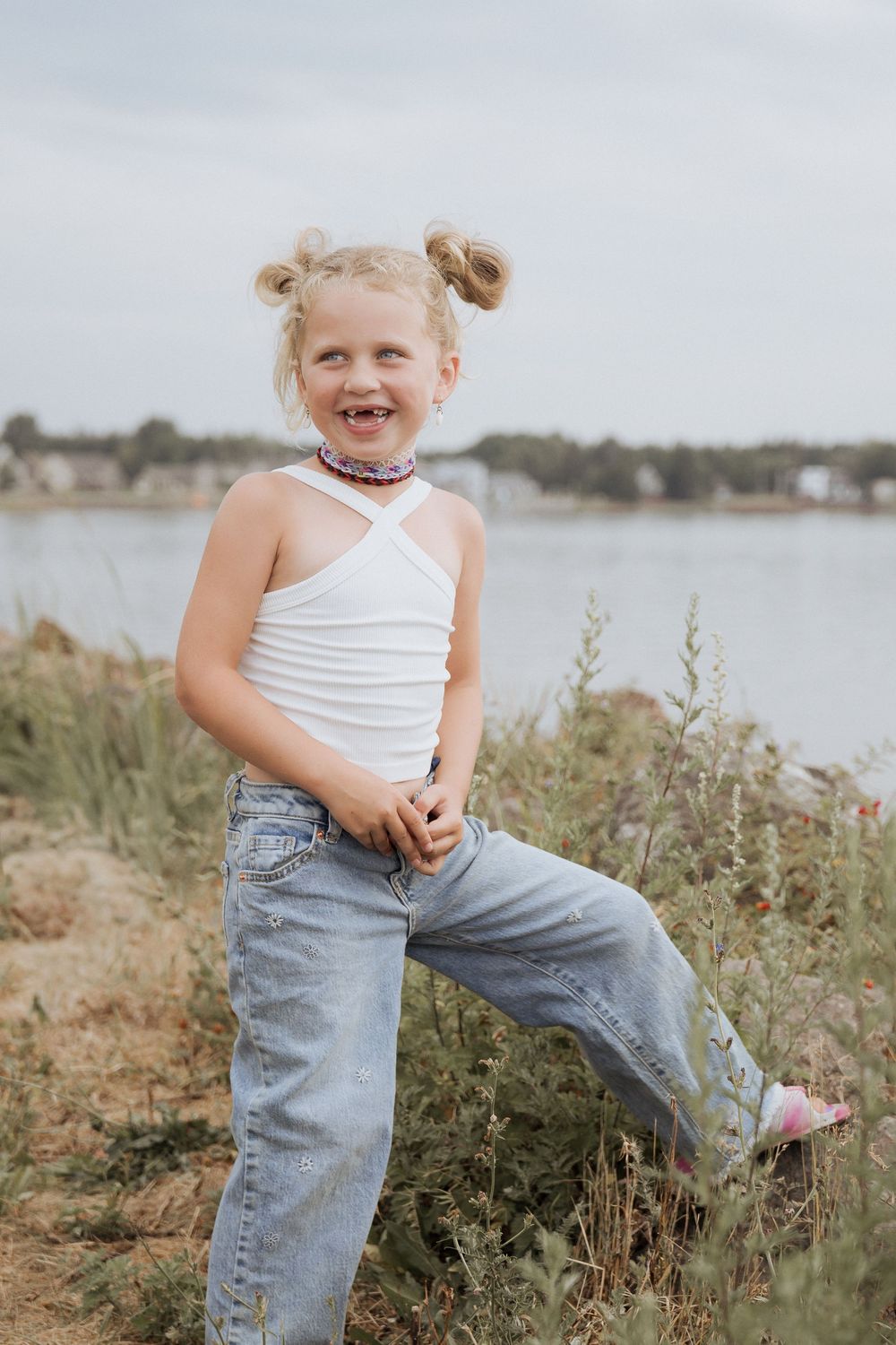 Child photographer Shediac New Brunswick photographer near me, girl playing in a field near the marina wharf, outdoor summer photography
