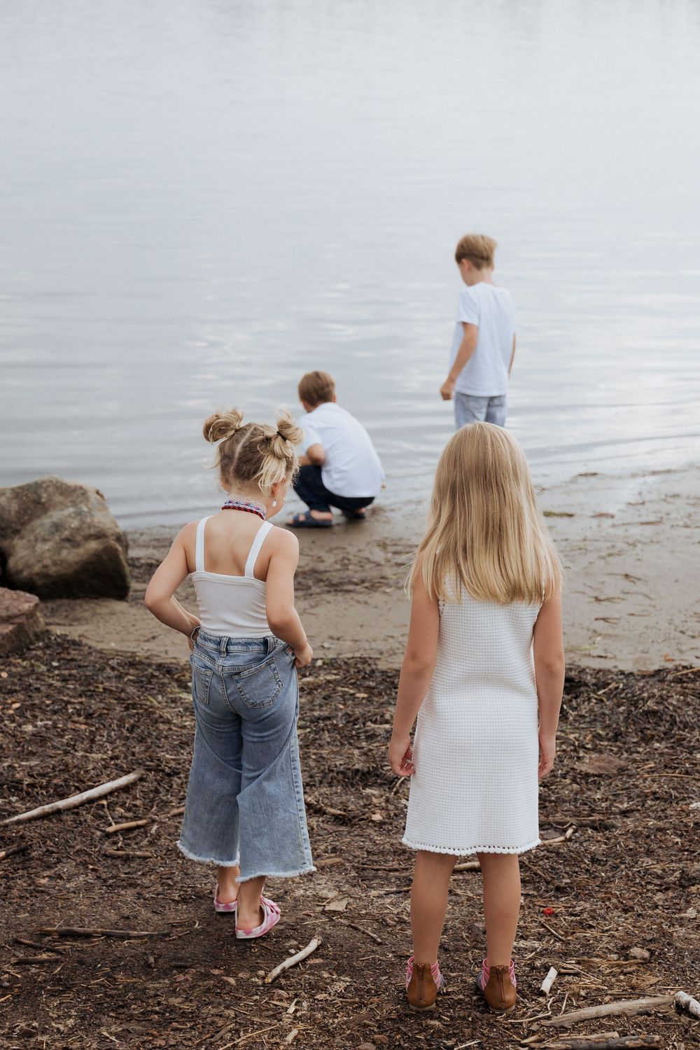 cousins playing in the water during fishing themed family photography session, childhood photographer, candid moment, authentic photos