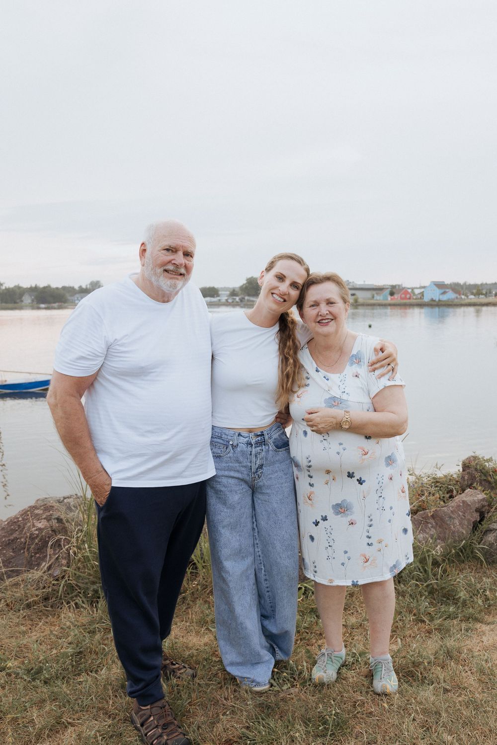 mom hugs her parents during extended family portrait session, Memramcook photographer, New Brunswick family photographer, summer outdoor