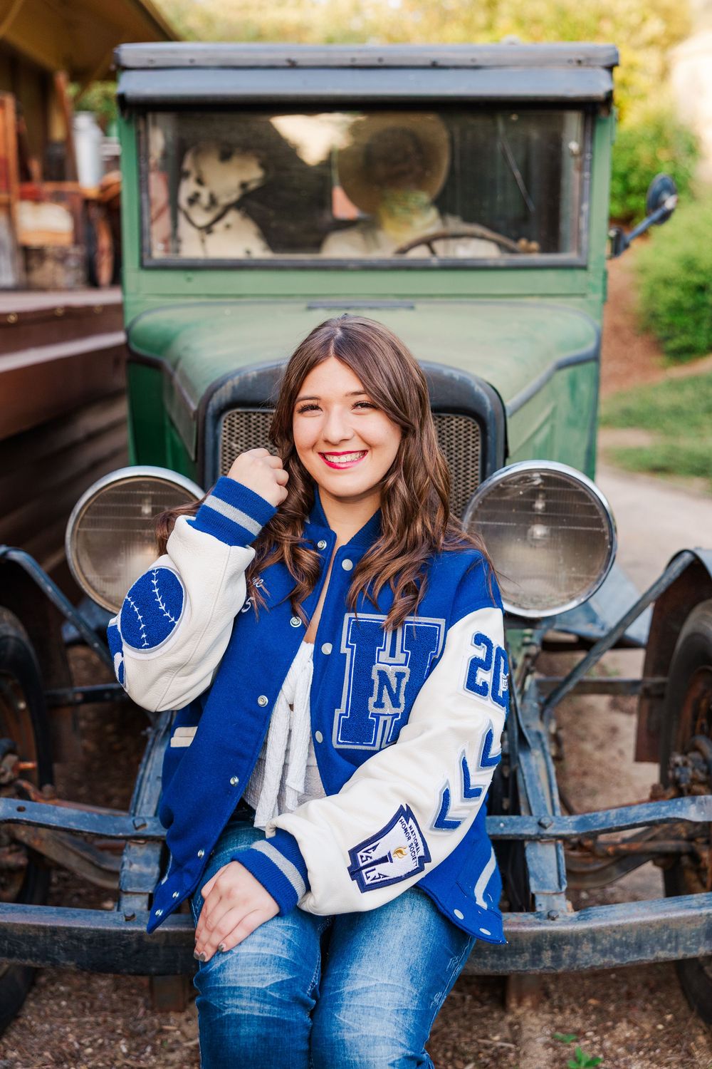 Vintage green train car provides rustic backdrop for casual athletic wear photoshoot.
