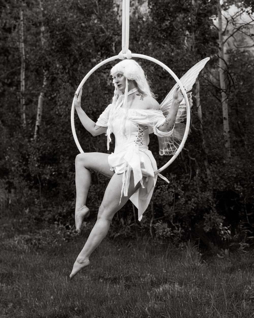 Poised aerialist on hoop — capturing the artistry, control, and emotion of aerial dance through fine art performance photography.