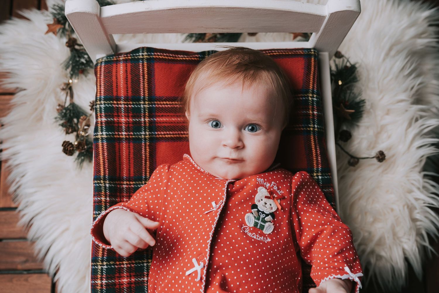 A series of photos showing a baby in a red polka dot outfit against plaid and white fur backgrounds.