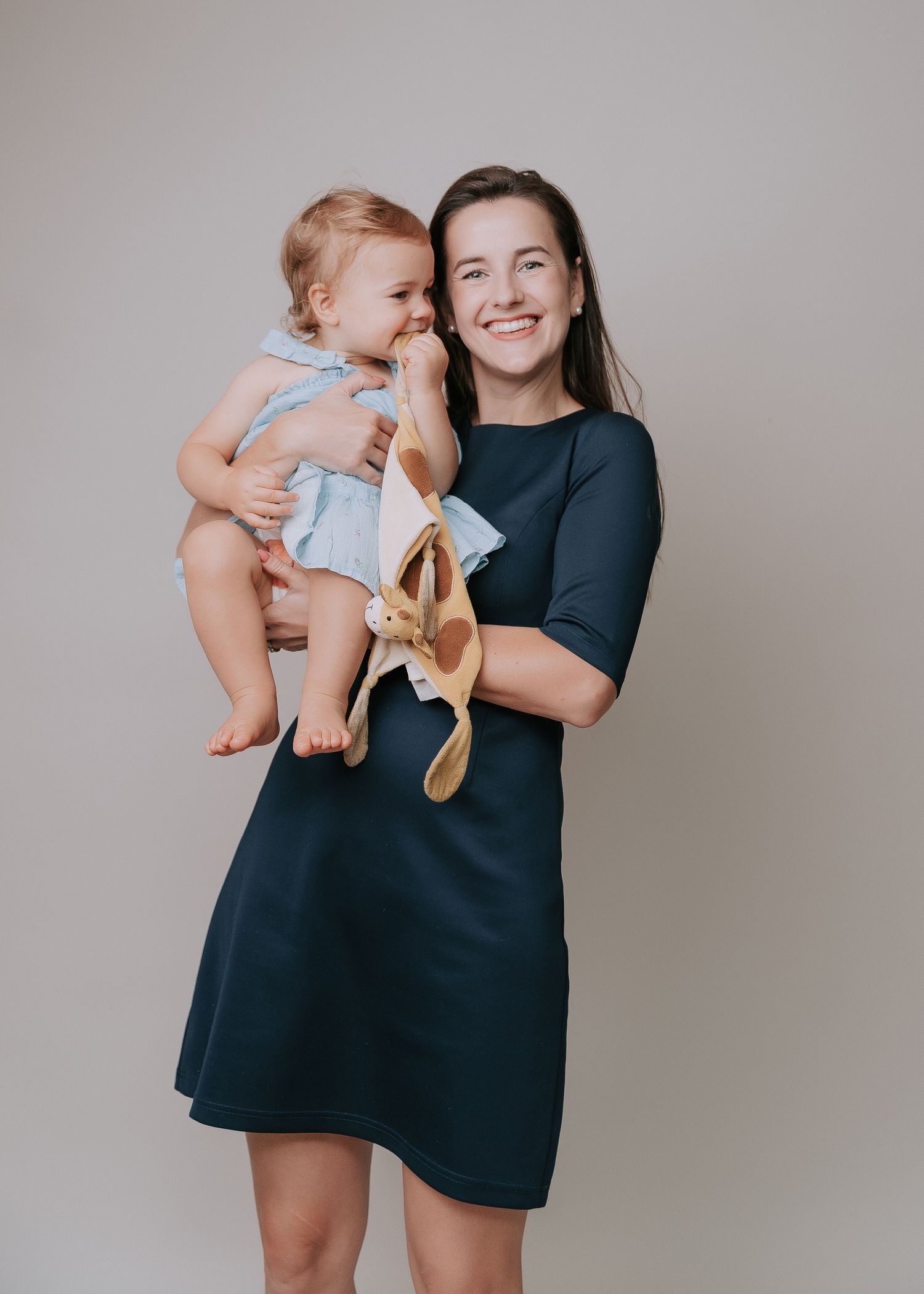 A series of photos showing a baby being playfully held and lifted in the air while wearing light colored clothing.