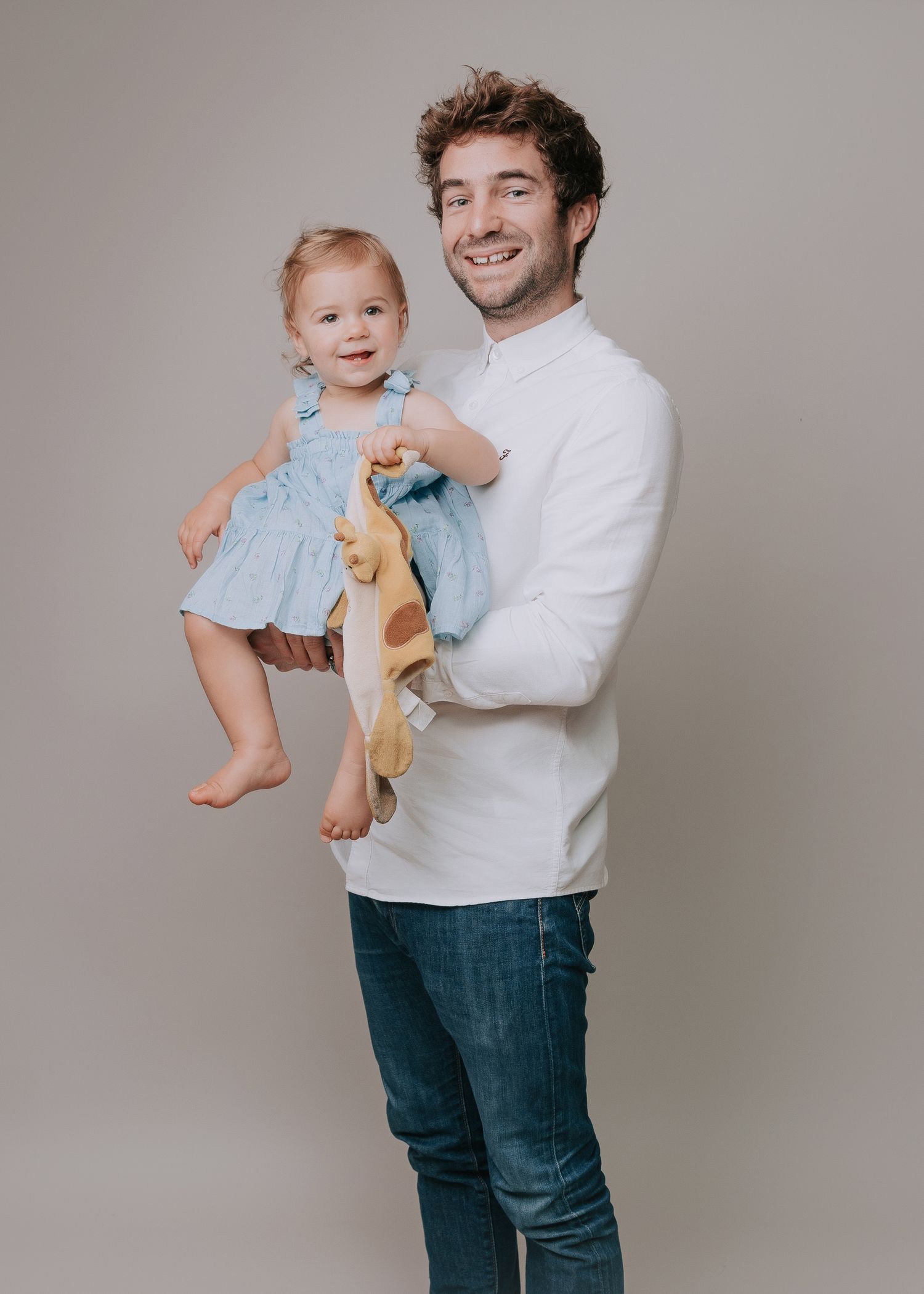 A joyful moment captured in a series of candid poses against a neutral grey studio backdrop.