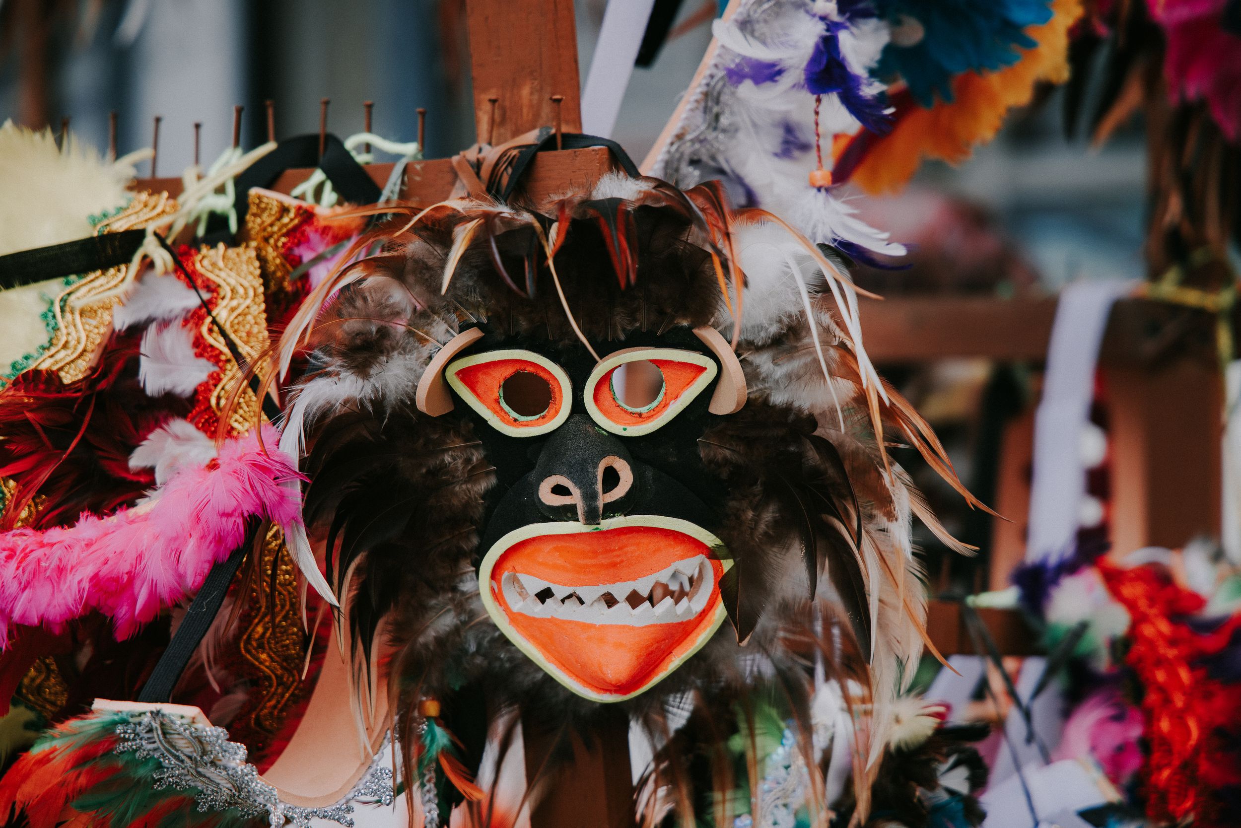 Colorful festival masks and decorative elements on display at a cultural celebration.