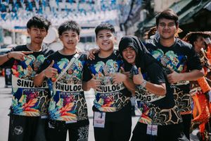 Group wearing matching black t-shirts with graphic designs at a community event.