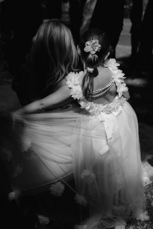 A series of black and white photos showing the flowing movement of a bride's white dress with floral details.