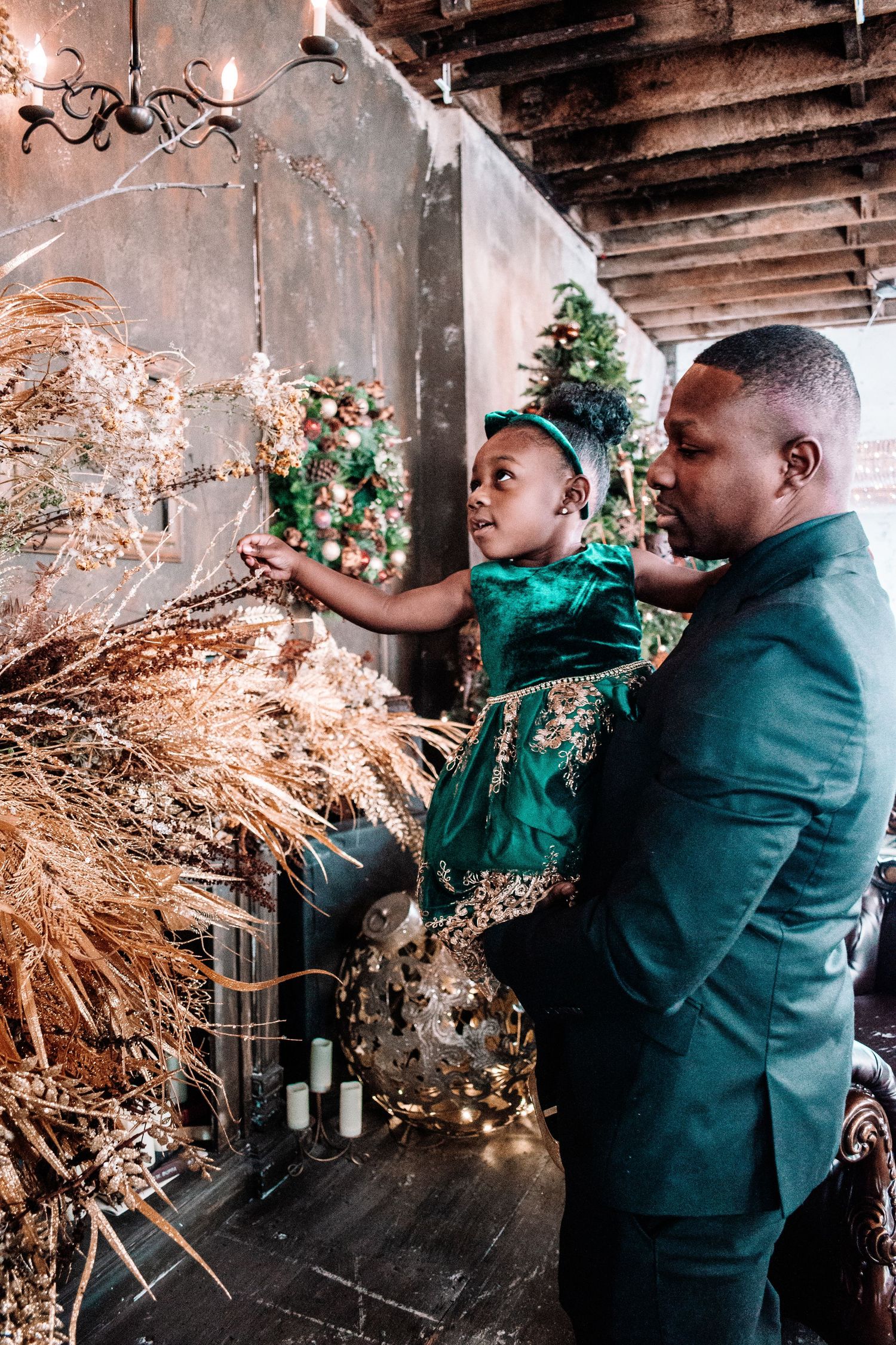Candid holiday moment of father and daughter decorating at IAMCREATIVESPACE studio in Tacoma.