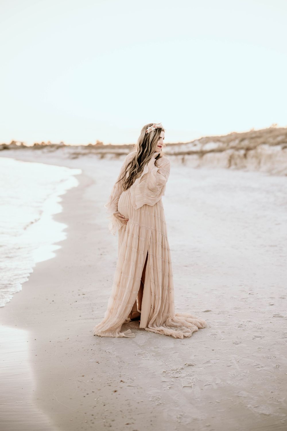 Panama City Beach photographer, family photos PCB, romantic seaside portrait with flowing beige gown and windswept hair along the shoreline.
