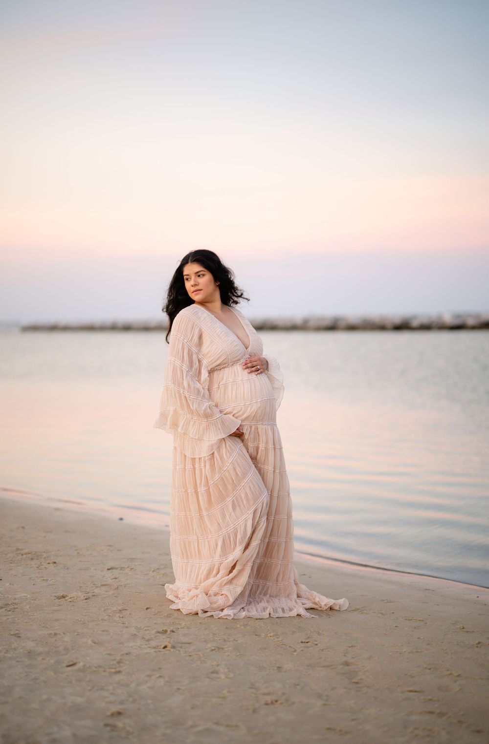 Panama City Beach photographer, family photos PCB, 30A photoshoot at sunset featuring a flowing blush-colored dress on a peaceful beach.
