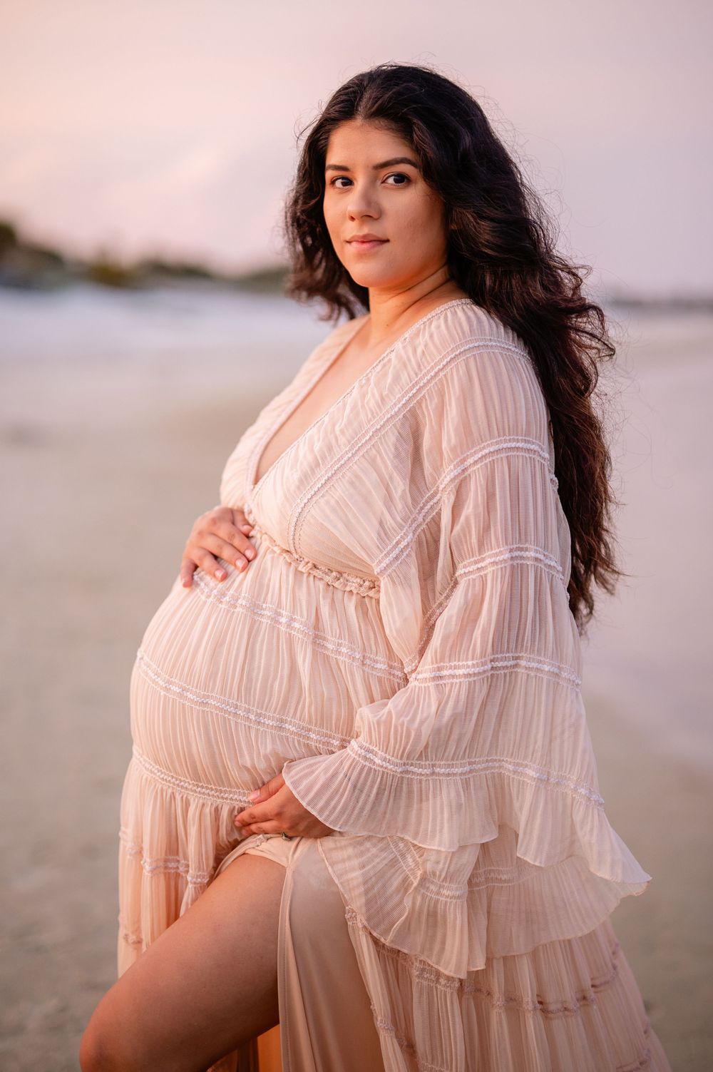 Panama City Beach photographer, family photos PCB, 30A maternity portrait featuring a detailed peach dress on a serene beach setting.