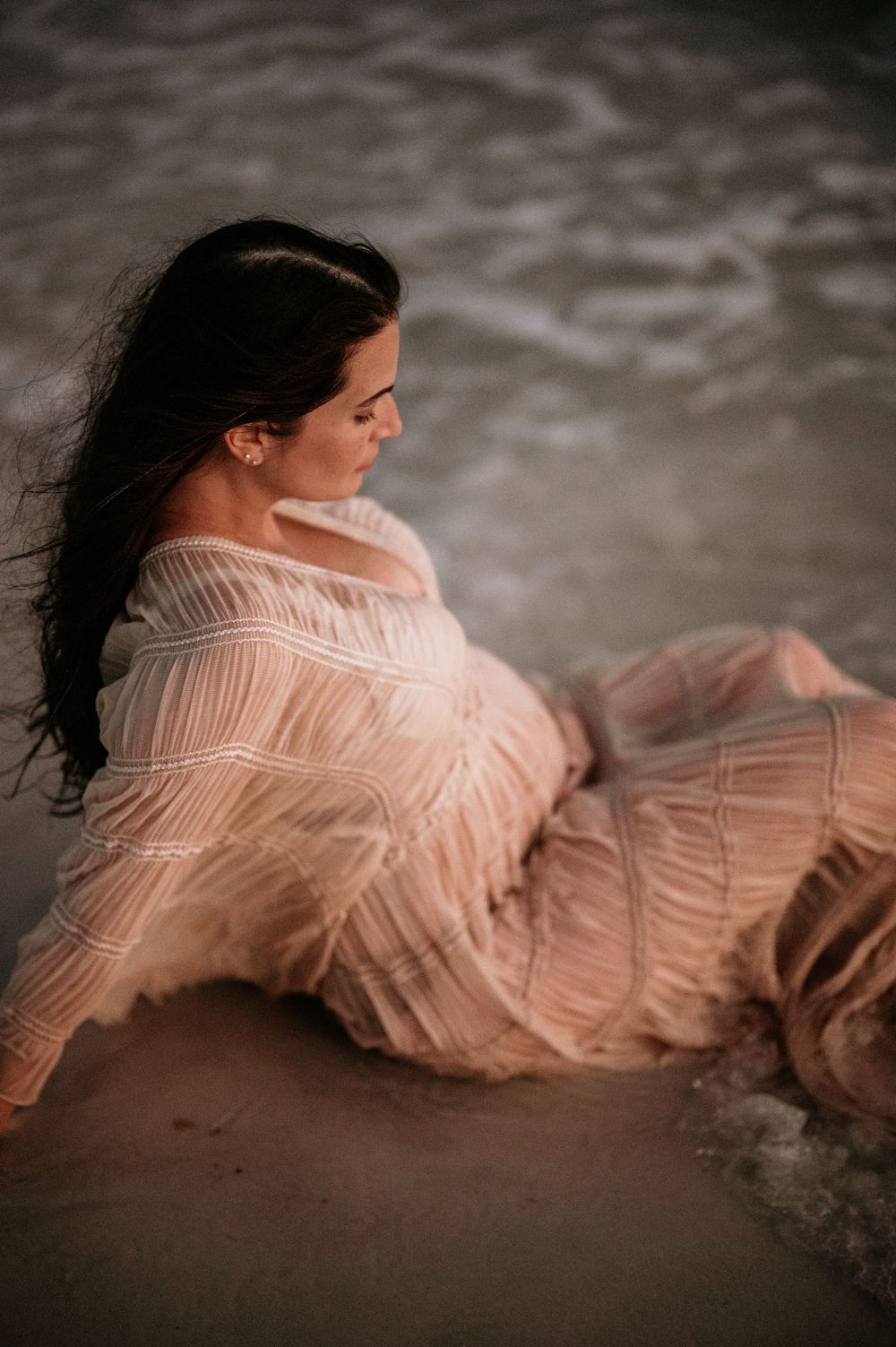 Panama City Beach photographer, family photos PCB, 30A beach maternity photo with peachy dress and gentle waves at dusk.