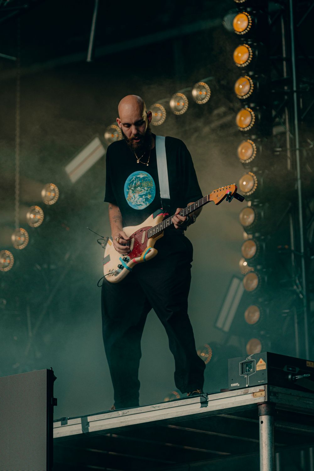 EDM artist San Holo captured during a set at Metamorphosis Music & Arts Festival in Orlando, FL. Artist is holding a guitar
