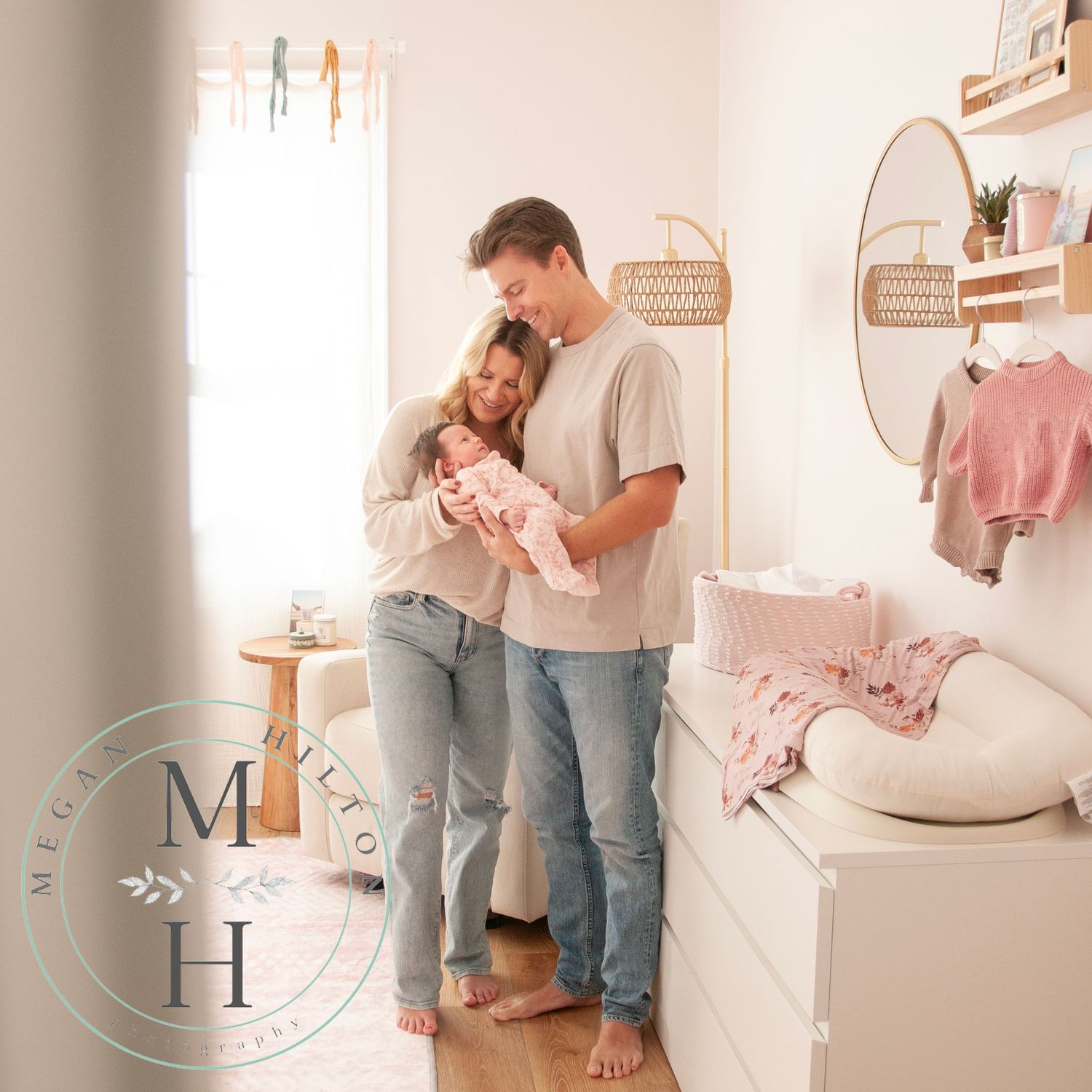mom and dad with newborn in nursery, photo from doorway