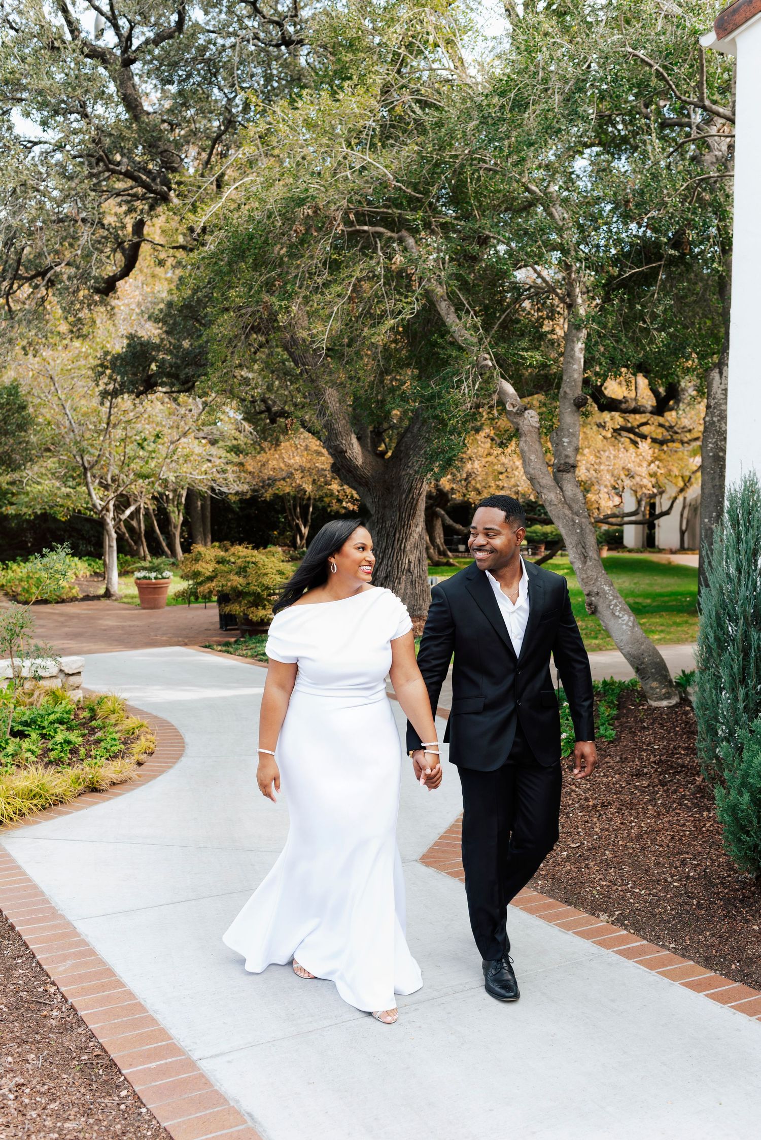 Candid engagement photo in the Woman’s Garden with lush greenery