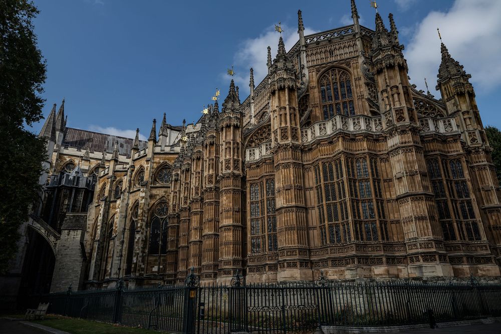 A panoramic sequence of exterior views showing the Gothic architecture of Lincoln Cathedral against a blue sky.