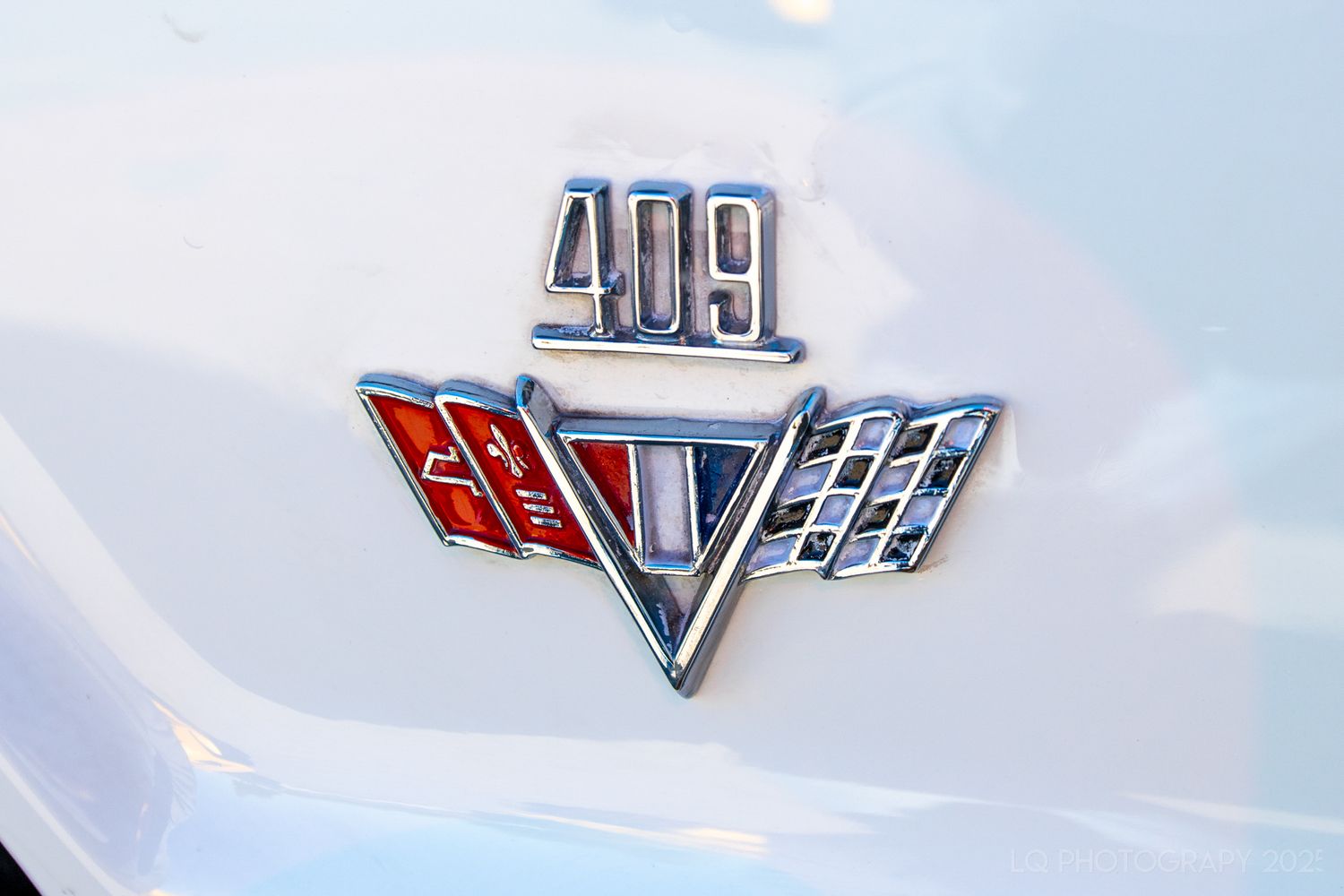 Close-up shots of classic car emblems and badges against white backgrounds.