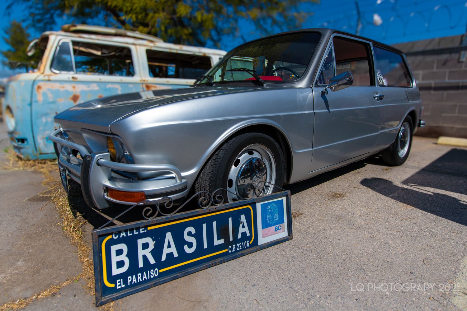 A vintage grey Volkswagen Brasilia car with classic license plate parked outdoors.