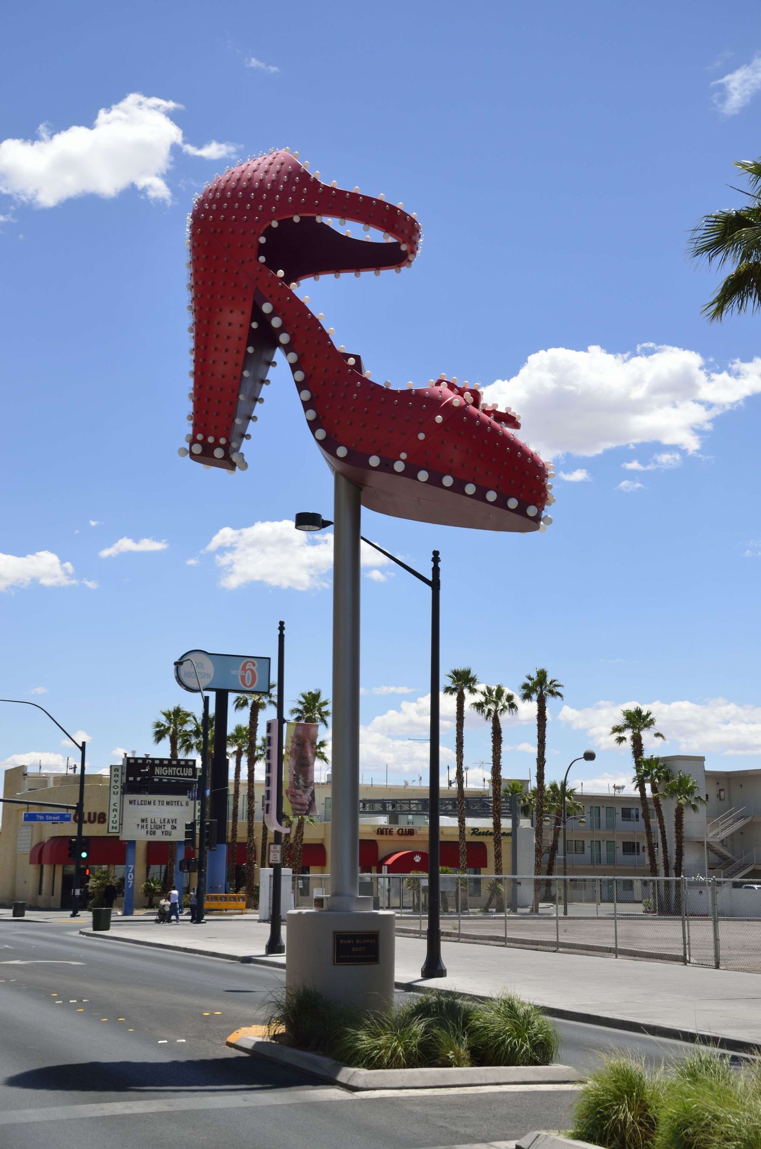 Giant red high heel shoe sculpture displayed as a roadside landmark in Las Vegas.