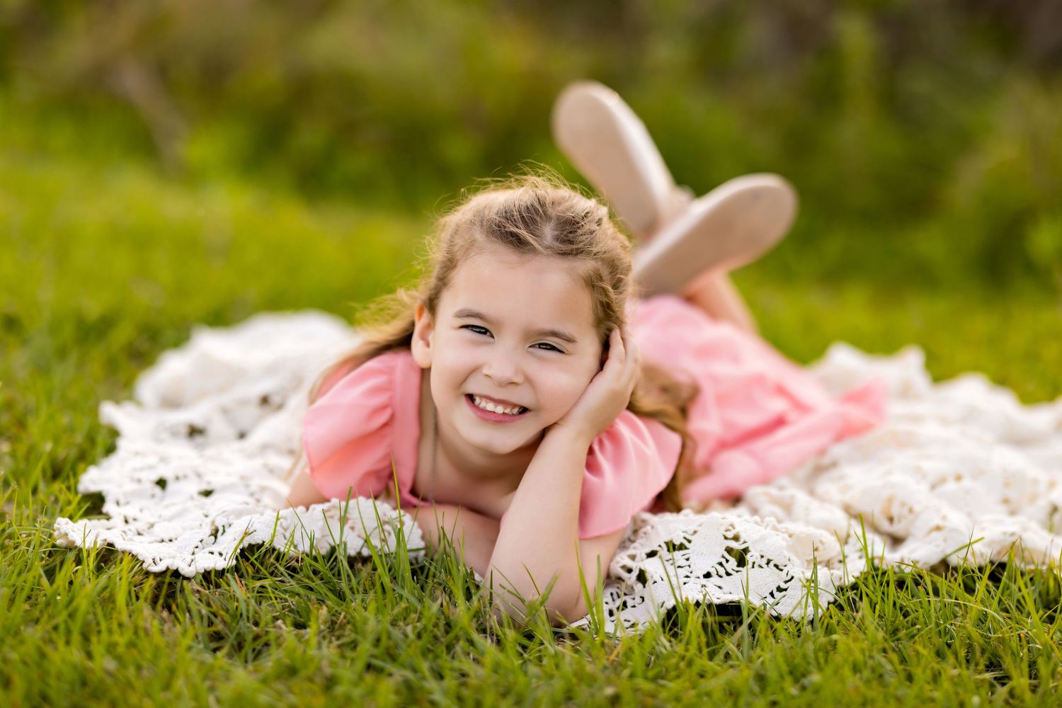Playful pose on white lace blanket in a grassy outdoor setting at sunset. Photos by Tampa Photographer DigitalMyst Photography