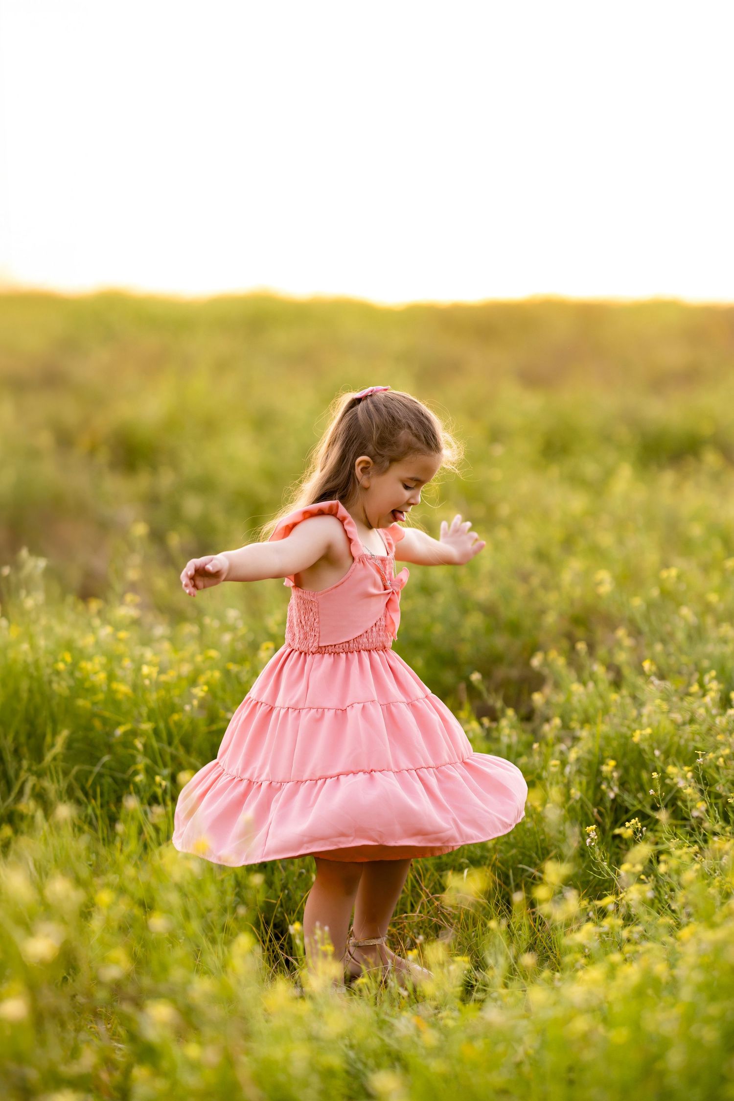 Spinning and dancing in a pink dress among wildflowers at sunset. Photos by Tampa Photographer DigitalMyst Photography