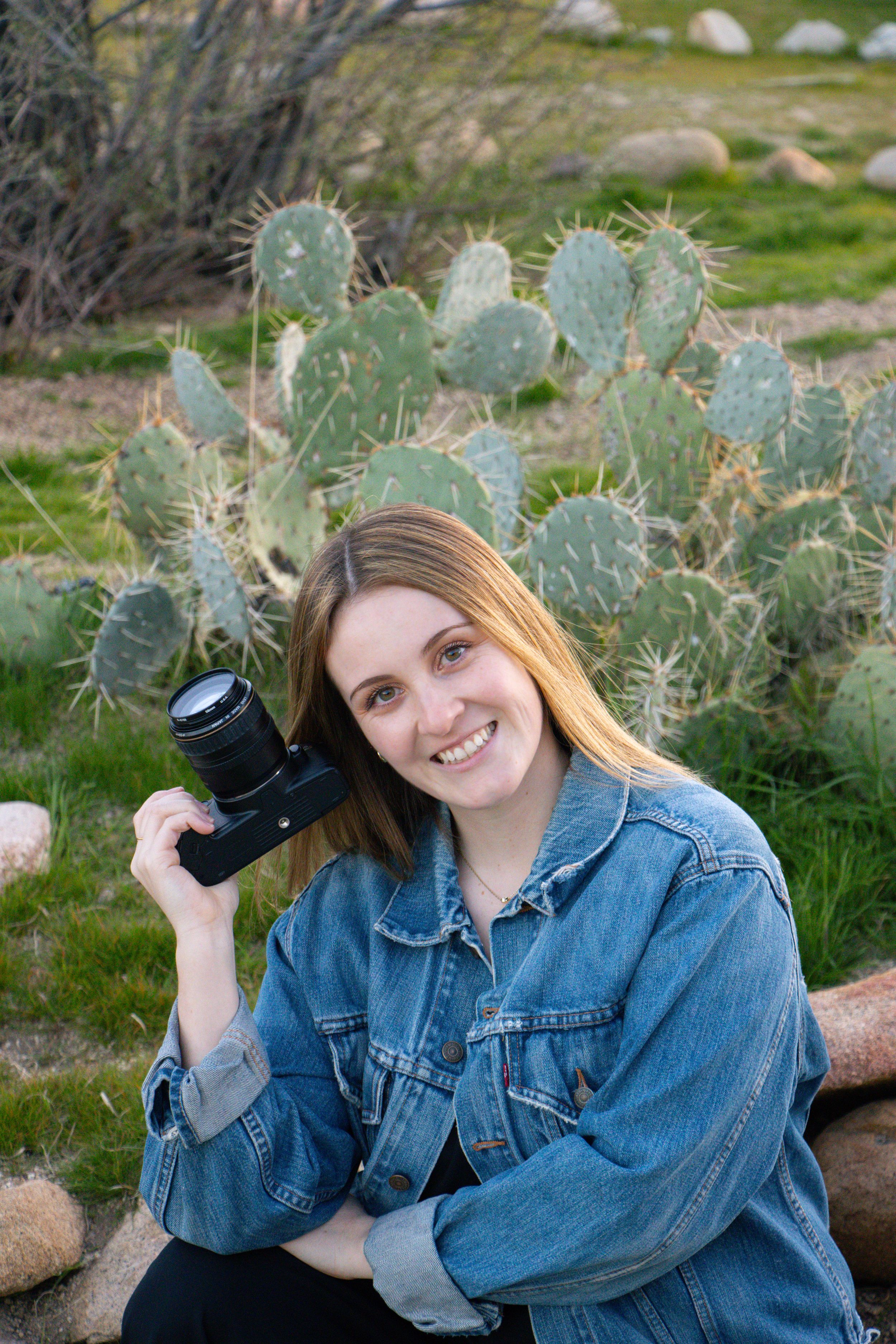 Studio photography session with camera equipment against white backdrop.