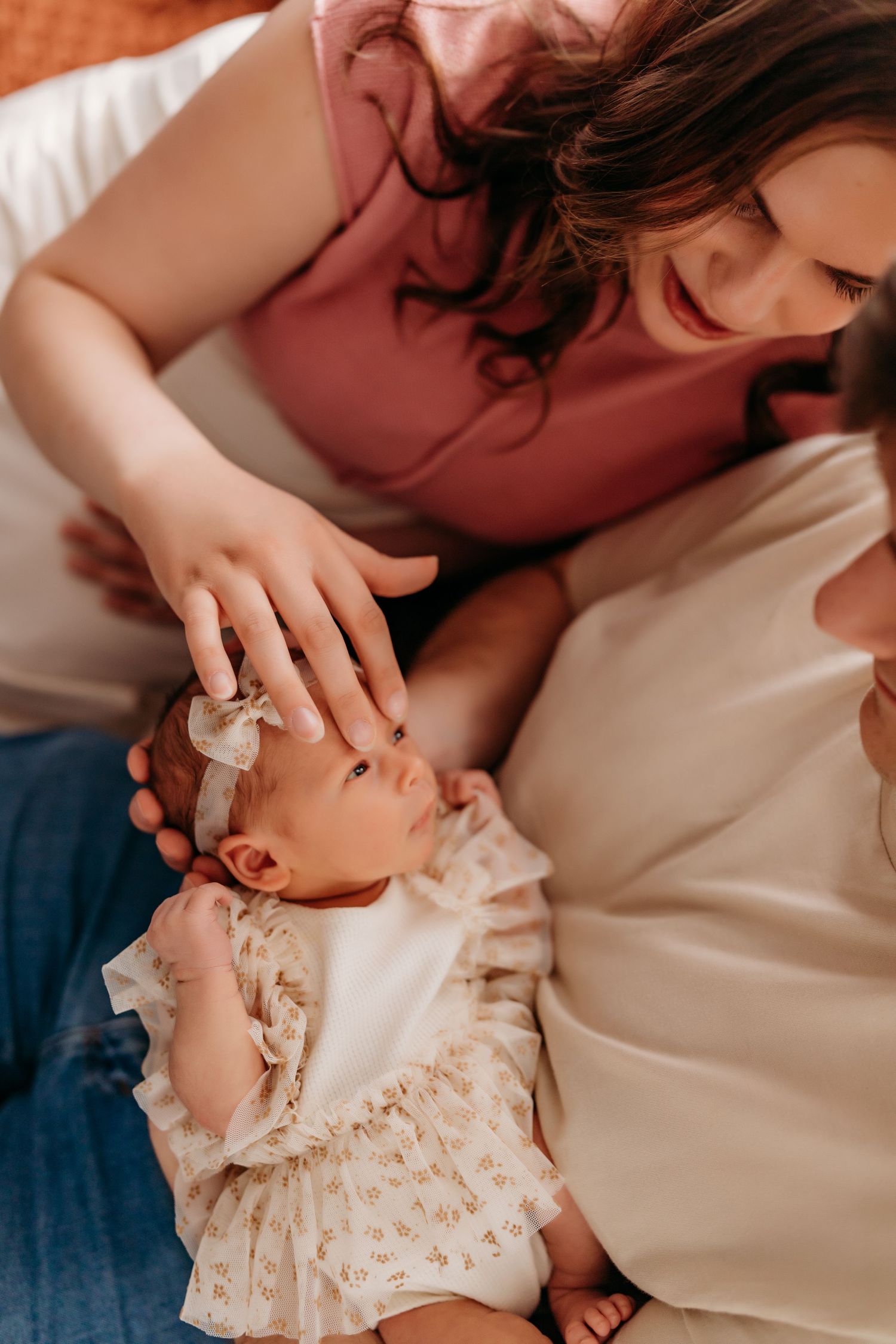 Intimate lifestyle newborn session with delicate lace details and soft natural lighting.