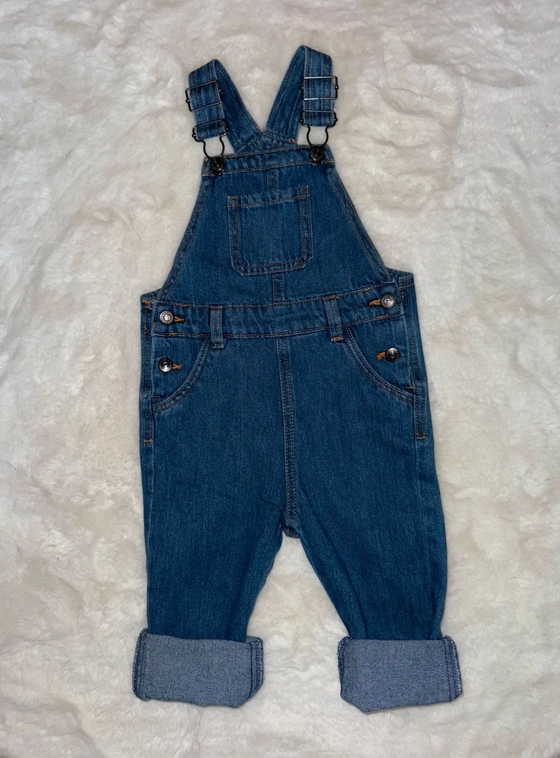 Classic blue denim overalls for children displayed flat on a white background.